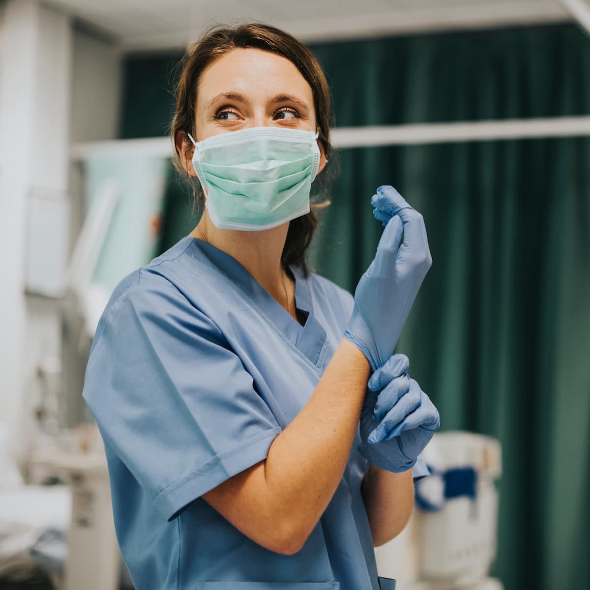 Nurses putting on medical gloves