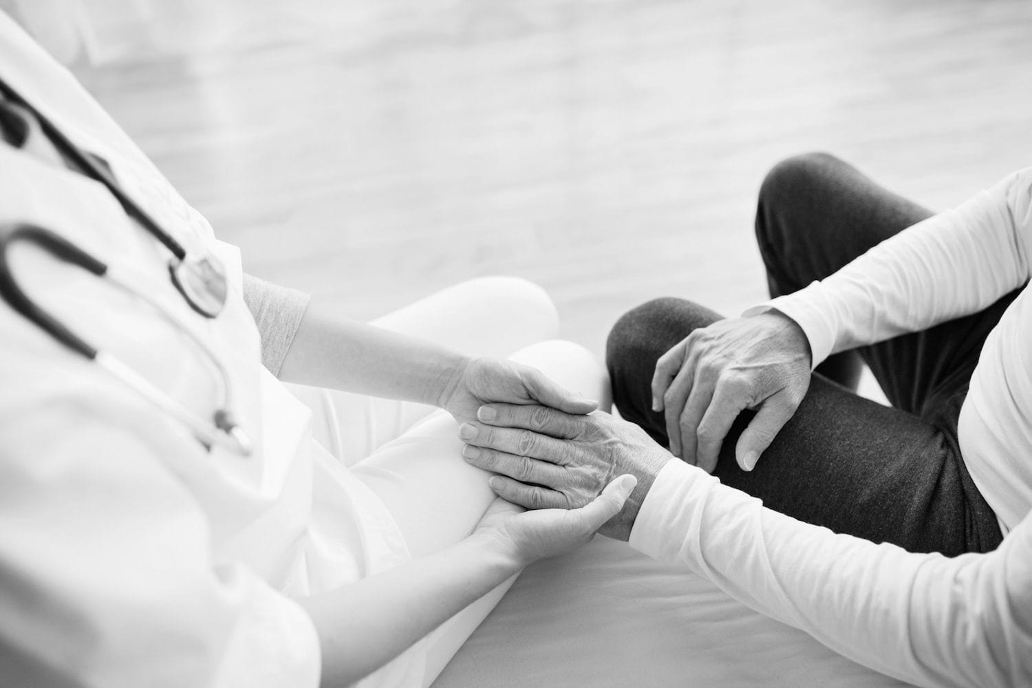 Doctor and patient holding hands