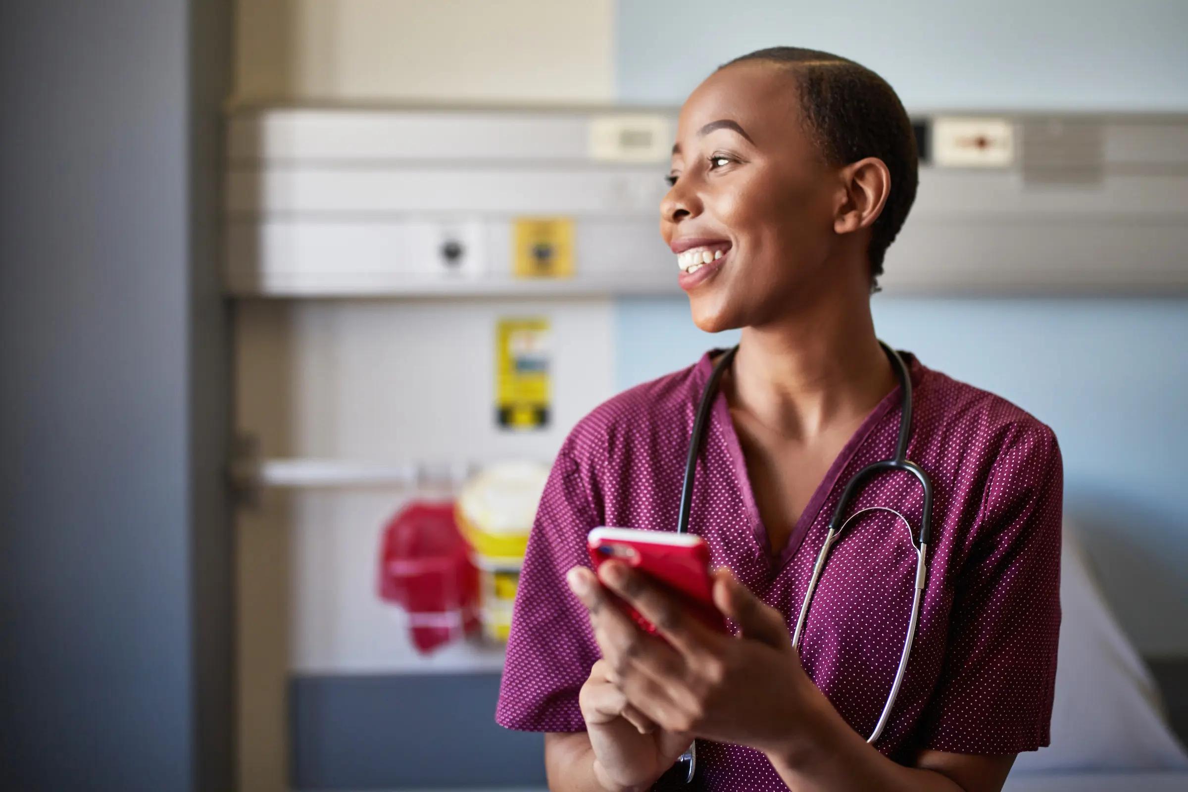Nurse using a cellphone in a hospital ward
