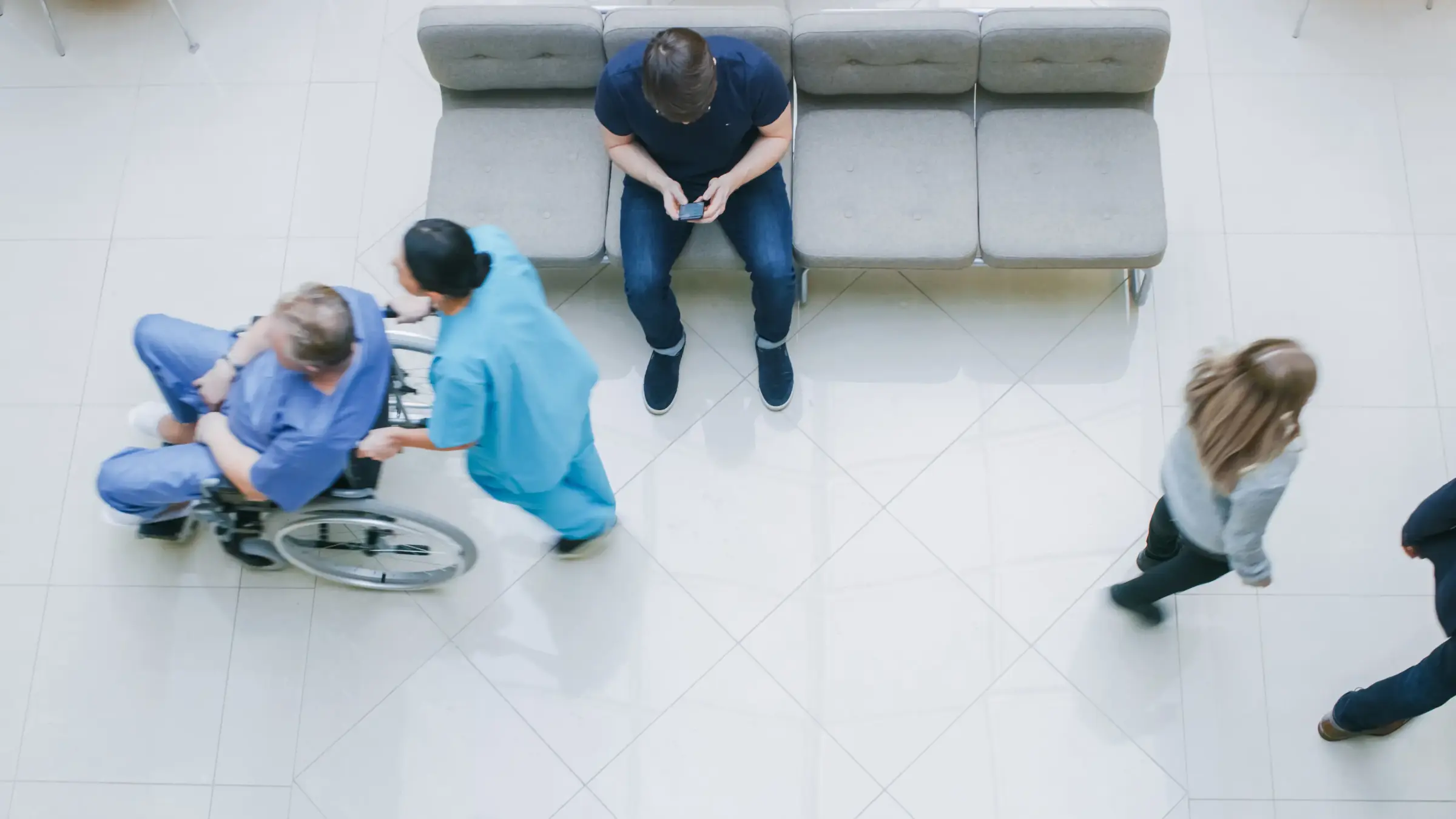 Patients and nurses in a busy hospital waiting area