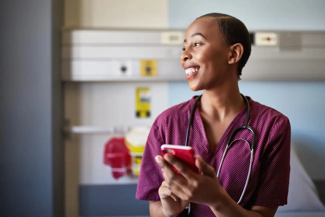 Nurse using a cellphone in a hospital ward